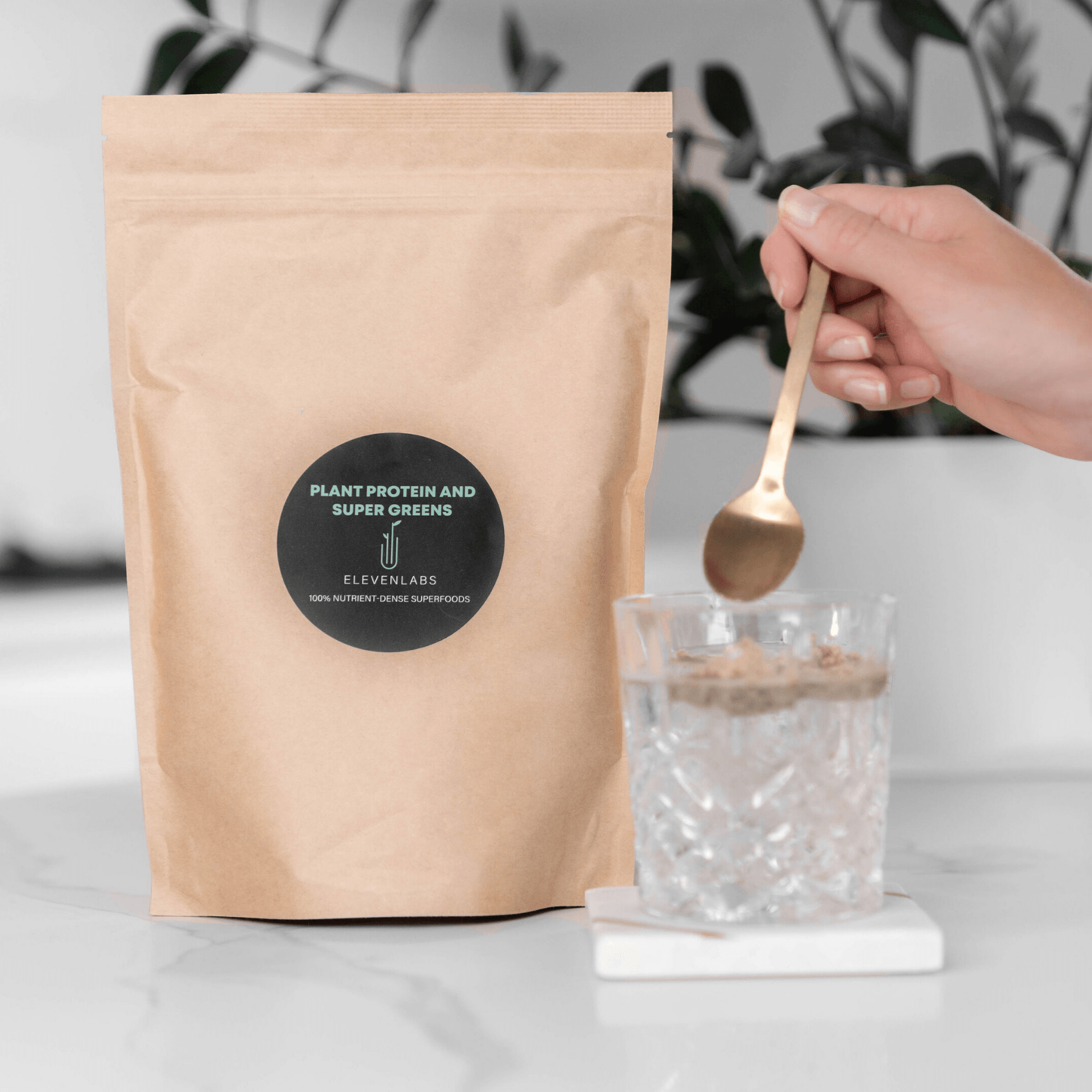 elevenlabs plant protein and super greens powder with glass